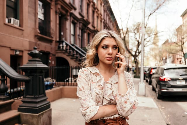serious woman talking on phone nYc