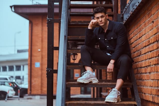 trendy guy on fire escape stairs
