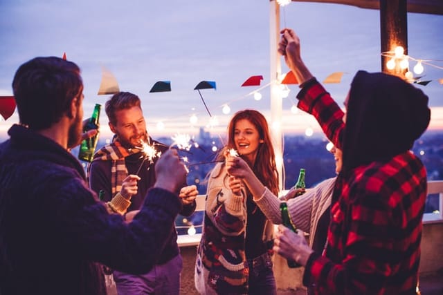 young couple at dusk party with friends