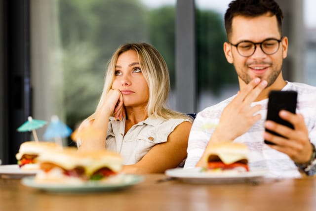 bored woman at lunch with boyfriend
