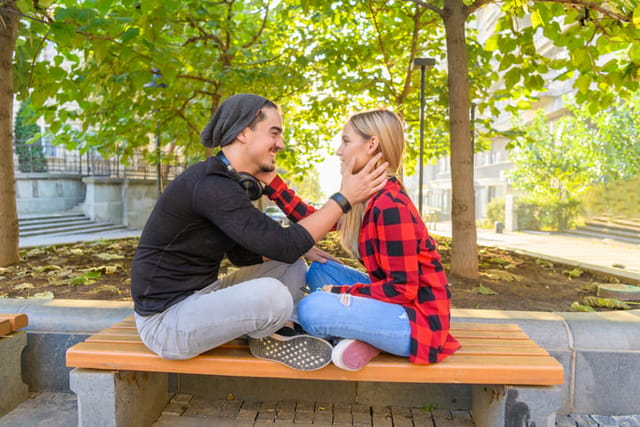 couple embracing on park bench