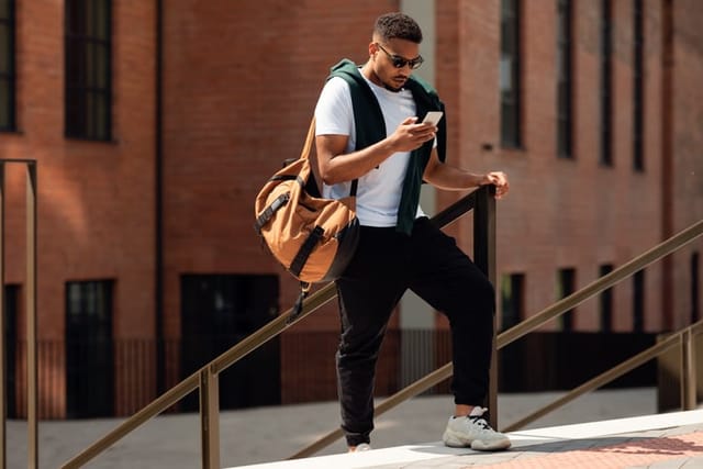 hipster guy texting outdoors