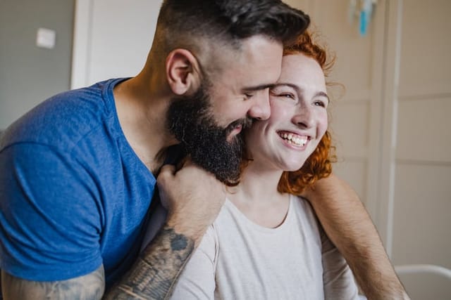 happy hipster coupling embracing smiling