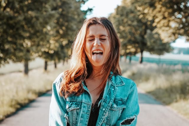 smiling girl sticking tongue out