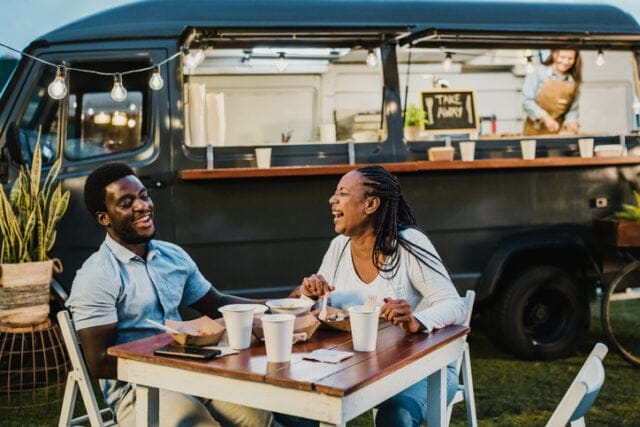 couple laughing at food truck