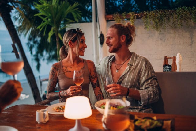 couple sharing romantic dinner at beach