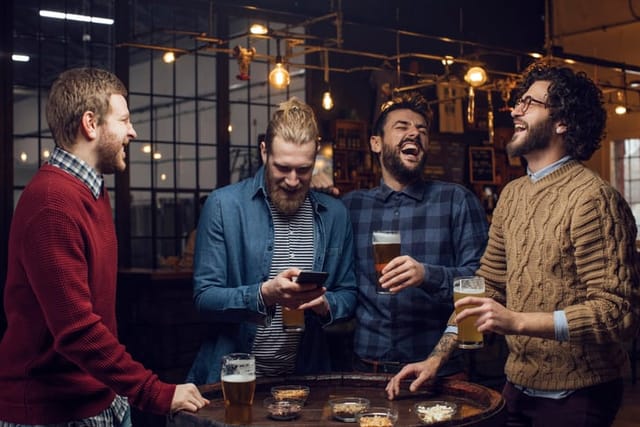 hipster guys drinking at bar