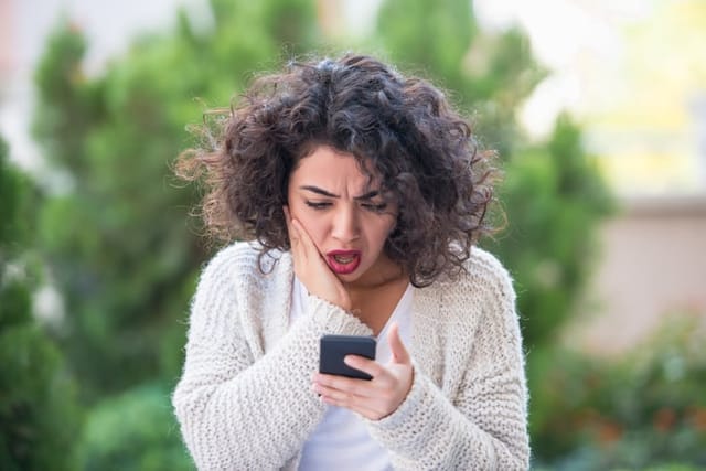 shocked young woman texting