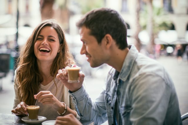 couple laughing over coffee