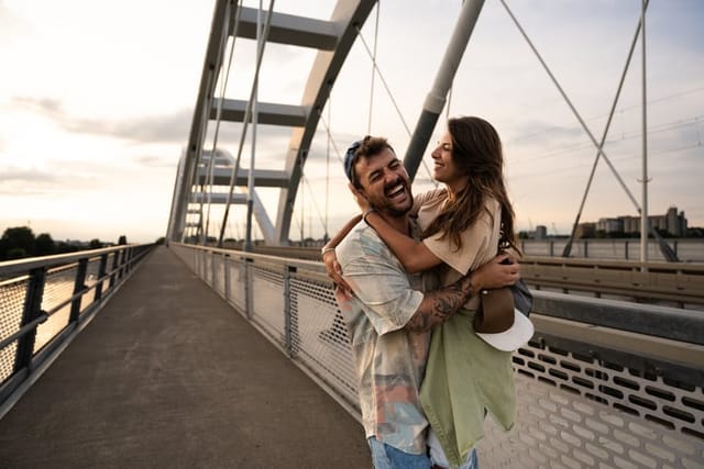 couple sharing a romantic moment on bridge
