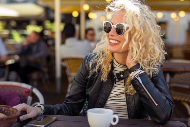 smiling woman in sunglasses outdoors