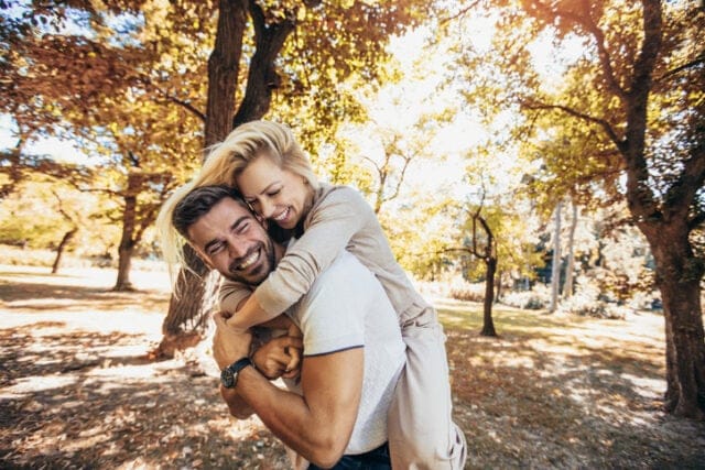 happy couple embracing autumn park