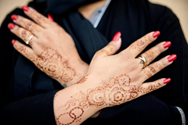 henna hands with red nails