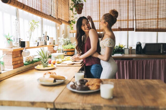 lesbian couple preparing meal together
