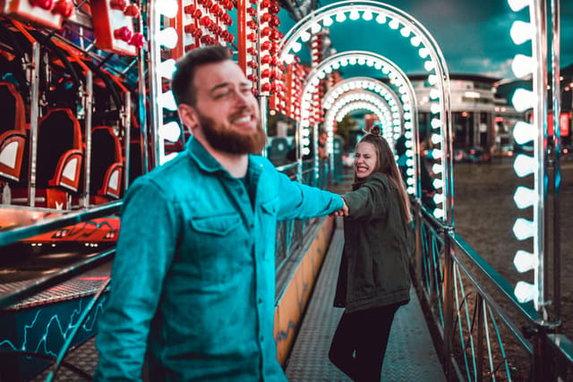couple enjoying fun at amusement park
