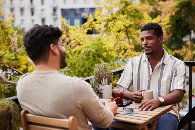 two men having a conversation at cafe
