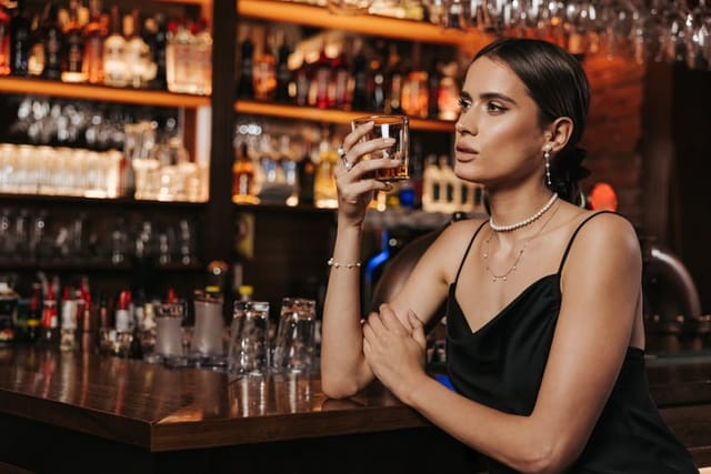 woman looking thoughtful at bar