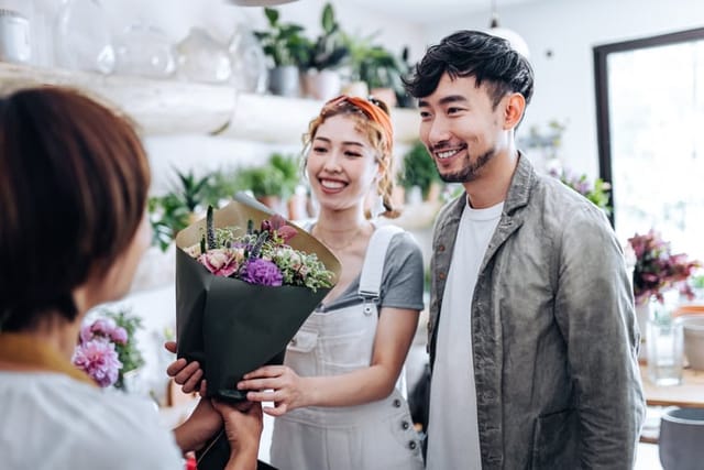 couple buying flowers in shop