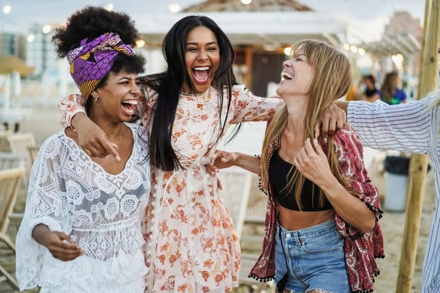 happy friends laughing at outdoor party