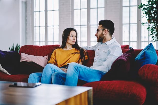 couple having serious convo on couch