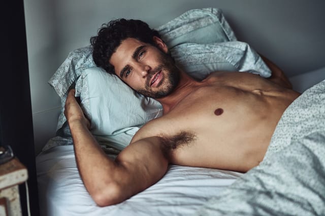 shirtless guy in bed