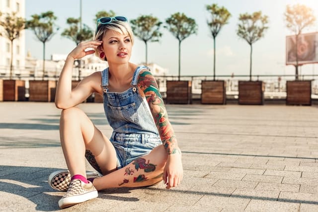 tattooed woman outdoors in summer