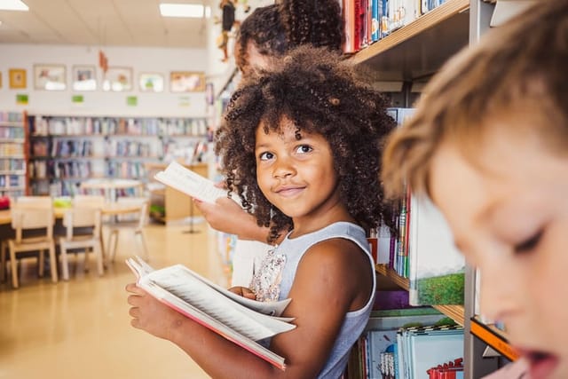 smiling little girl in library