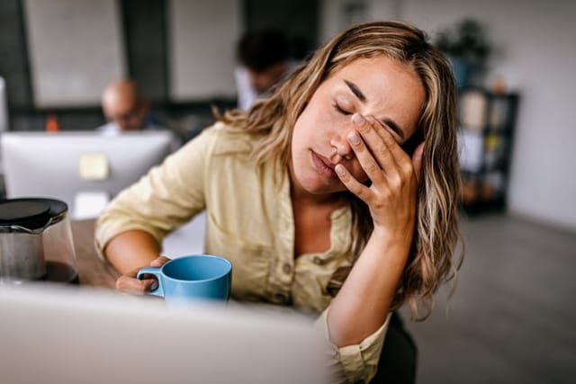 stressed woman sitting at computer