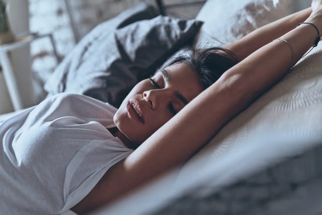 woman experiencing pleasure in bed