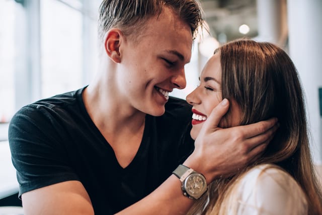 smiling couple kissing in love