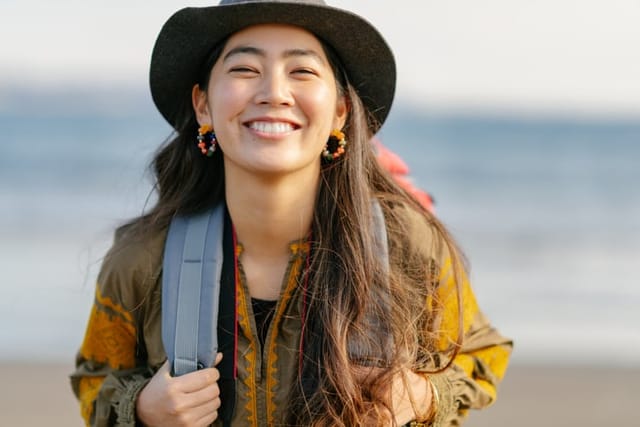 smiling female backpacker hiking outdoors