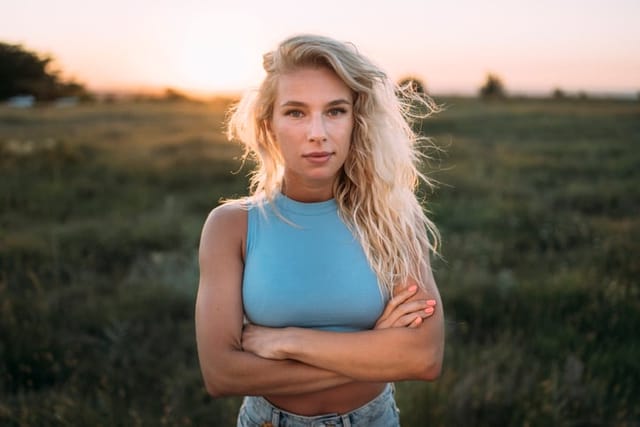 serious blonde woman outdoors at sunset