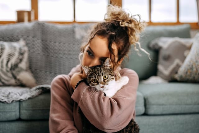 hipster woman hugging cat