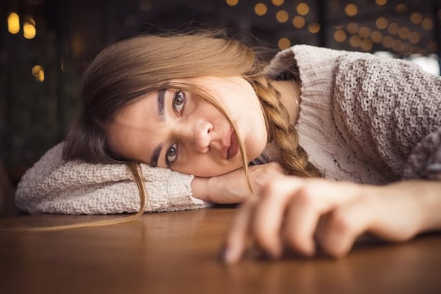 sad woman with head on table