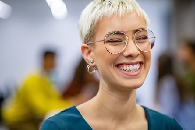 smiling woman with short blonde hair