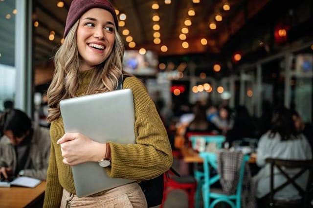 smiling millennial woman at coffee shop