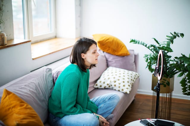 woman sitting on couch thinking