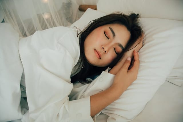 young woman sleeping in bed