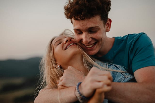 young happy couple embracing at sunset