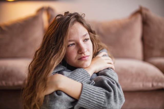 sad woman sitting in living room