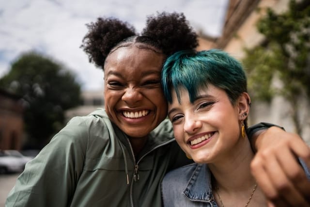 two female friends smiling for photos