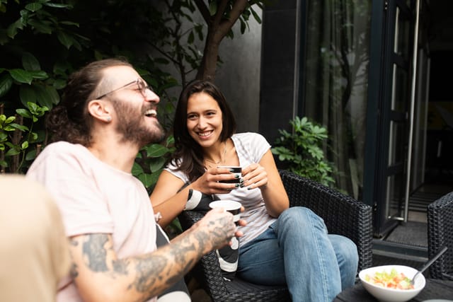 couple laughing having coffee