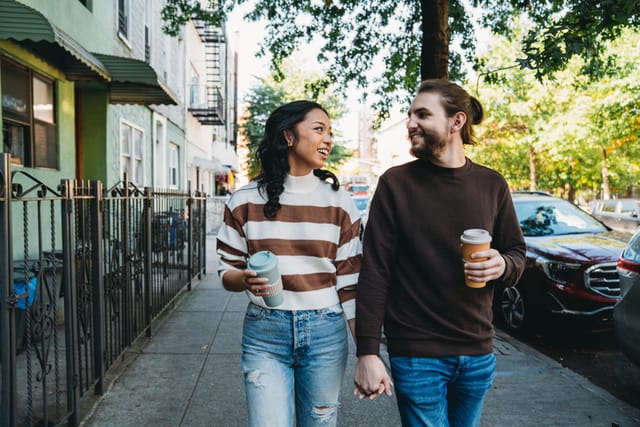 couple walking hand-in-hand brooklyn