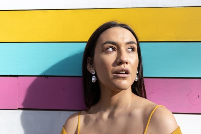woman looking to sky with colorful background
