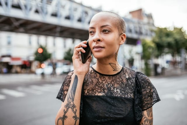 woman talking on phone city street