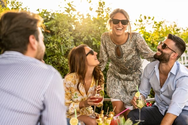 smiling friends having outdoor picnic