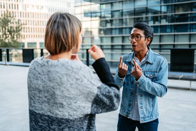 couple arguing in front of office building