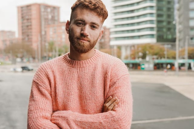redhead millennial man in city