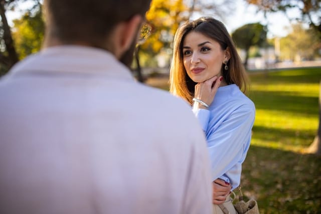 Young couple walking together in a public park