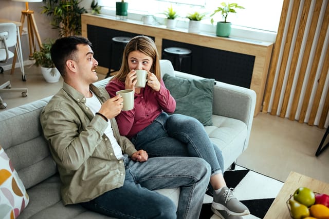 couple having coffee on the couch